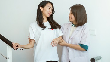 A nurse helping a patient