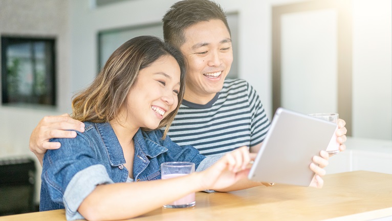 A couple looking at a tablet