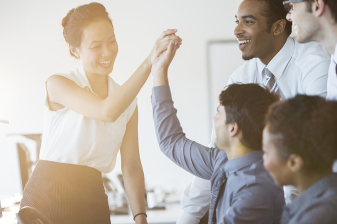 A man and a lady high fiving with three people looking