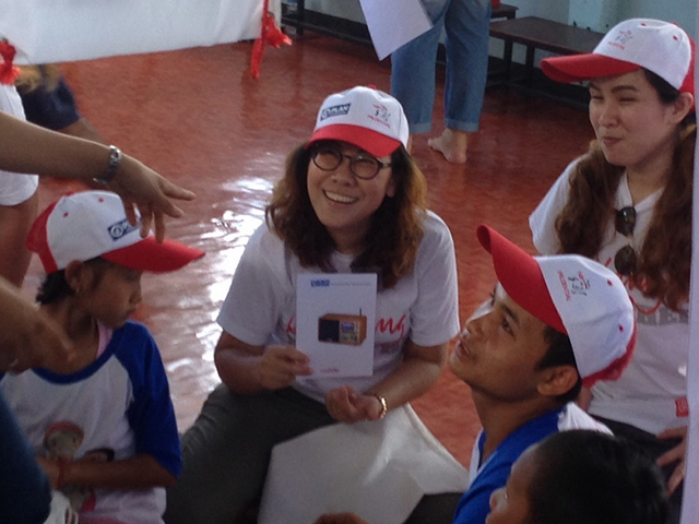 A volunteer smiling to the camera