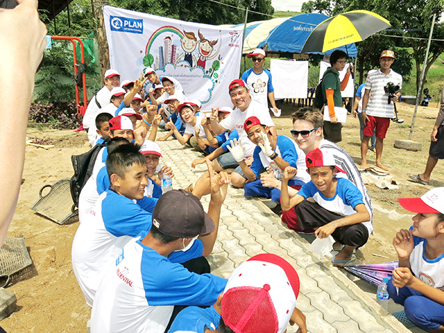 Volunteers and students smiling to the camera