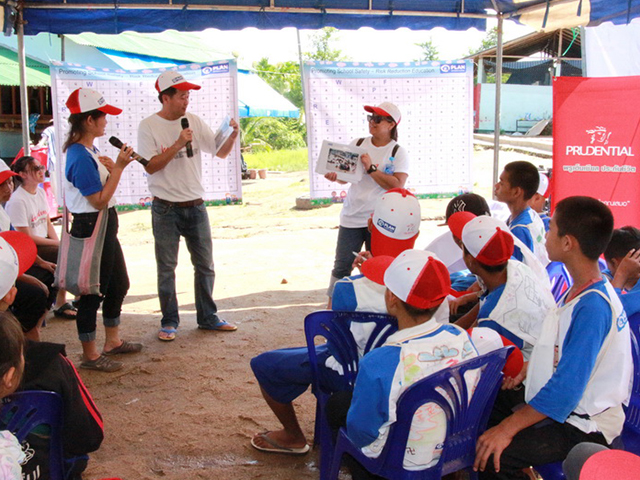 Volunteers presenting to a group of students