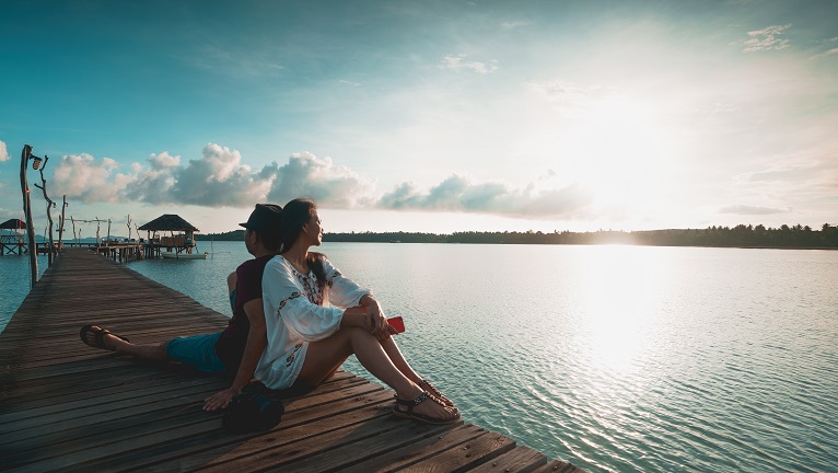 A couple sitting on a deck looking at the sky