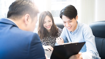 A couple talking to an agent