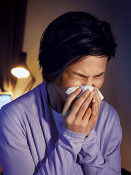 A lady sneezing